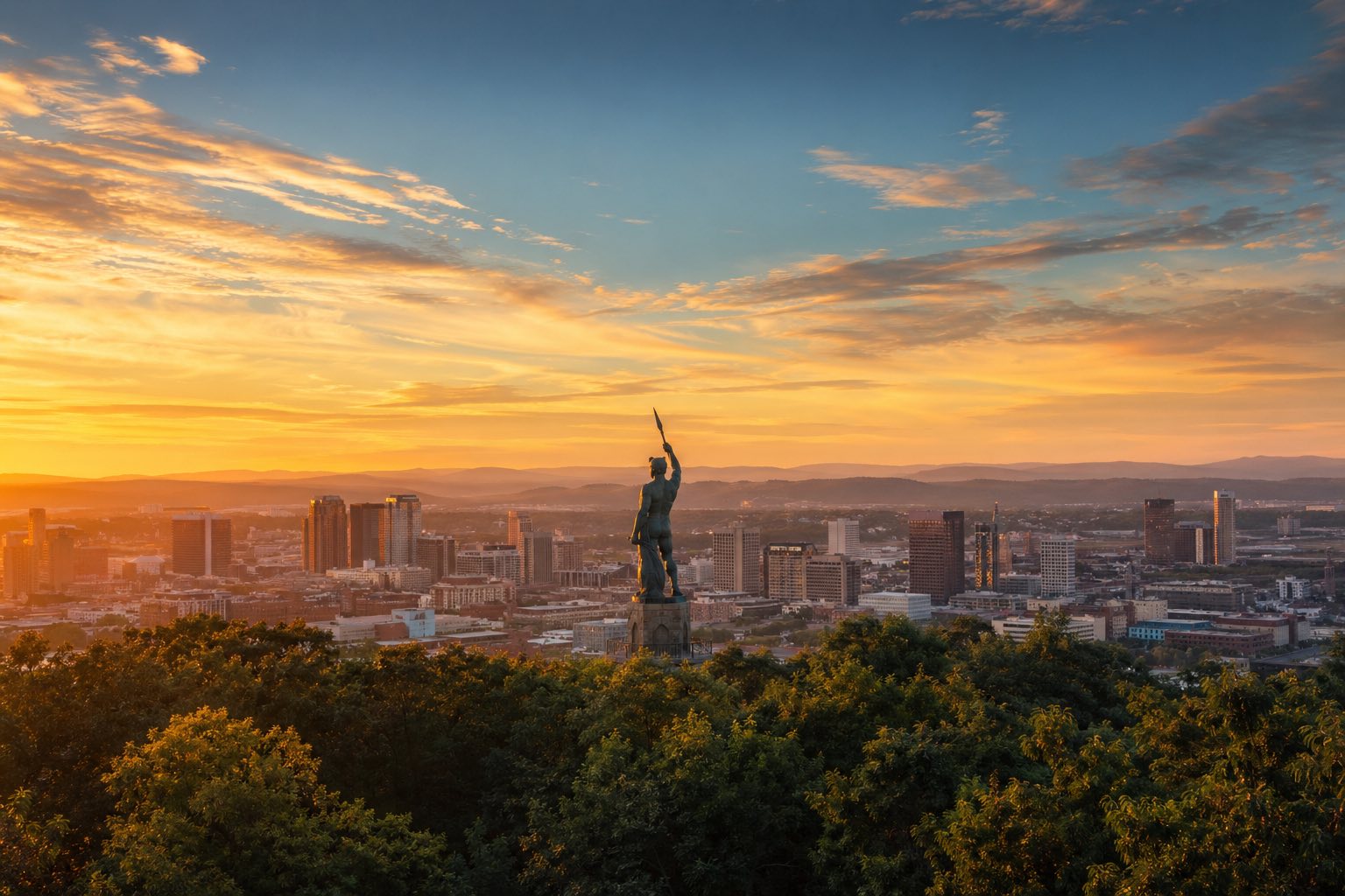 Modern photograph of the Birmingham skyline and Appalachian foothills at sunset representing Credo Enterprise' Alabama service area