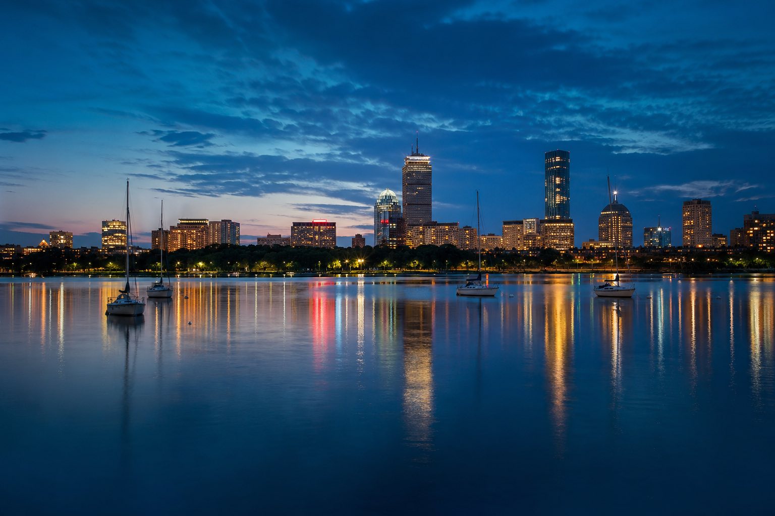 Modern photograph of the Boston skyline and Charles River at golden hour representing Credo Enterprise' Massachusetts service area